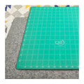 Quilters Select wool pressing mat with the green cutting surface on the reverse, 14 by 14 inches